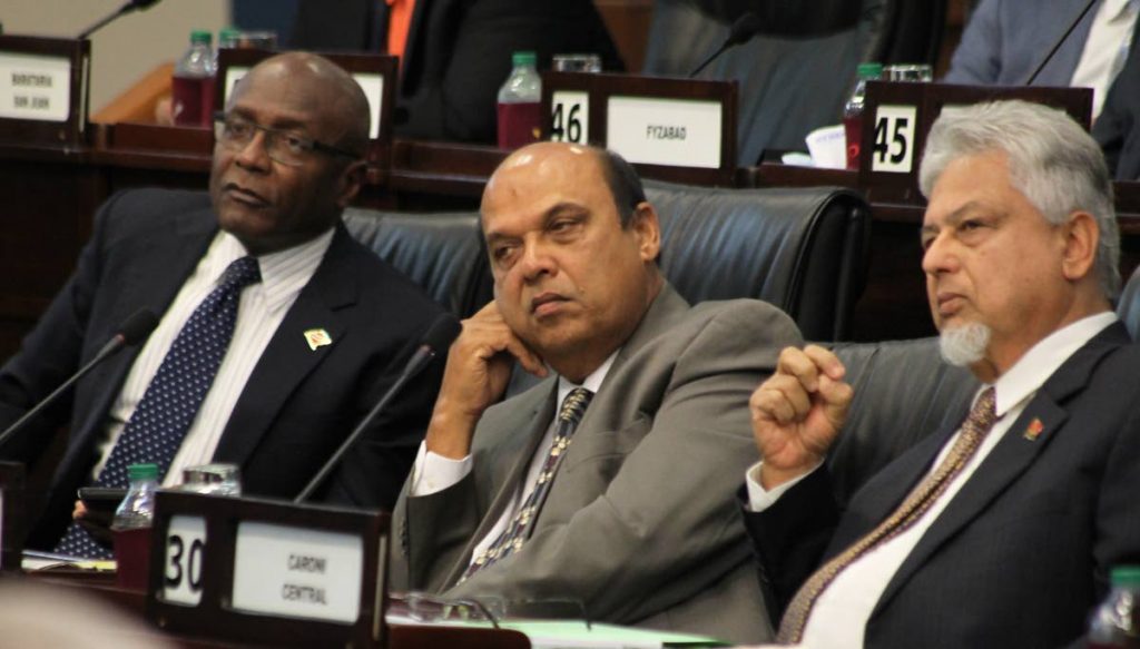 Opposition MPs Rodney Charles, left to right, Fazal Karim and Bhoe Tewarie listen glumly to a member on the Government bench during debate on the Unexplained Wealth Bill in Parliament on Friday. PHOTOS BY ROGER JACOB