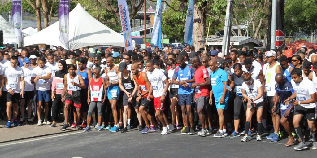 Participants, of the Massy Stores run For Food 5k, prepare to begin the race yesterday, at the Queen's Park Savannah, Port of Spain.