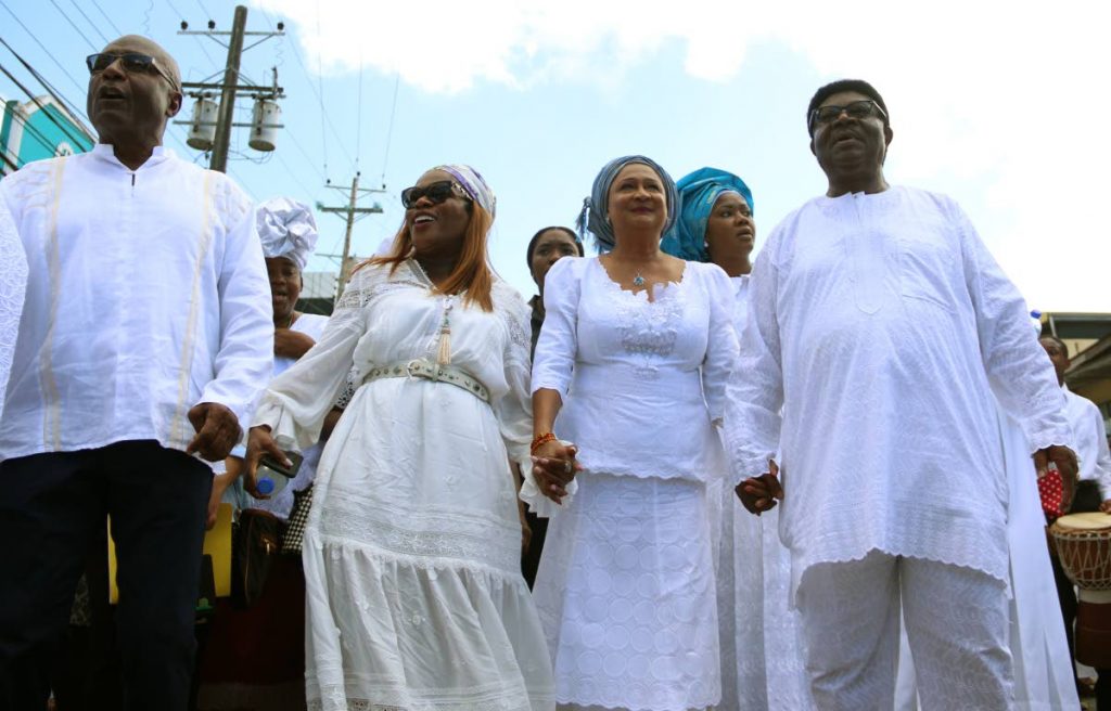 Naparima MP Rodney Charles, (left to right) UNC deputy leader Jearlean John, Opposition Leader Kamla Persad-Bissessar and Moruga/Tableland MP Clifton De Coteau celebrate with Spiritual Baptist/Shouter Liberation Day, observed last Saturday, in Princes Town yesterday. PHOTOS BY ANSEL JEBODH