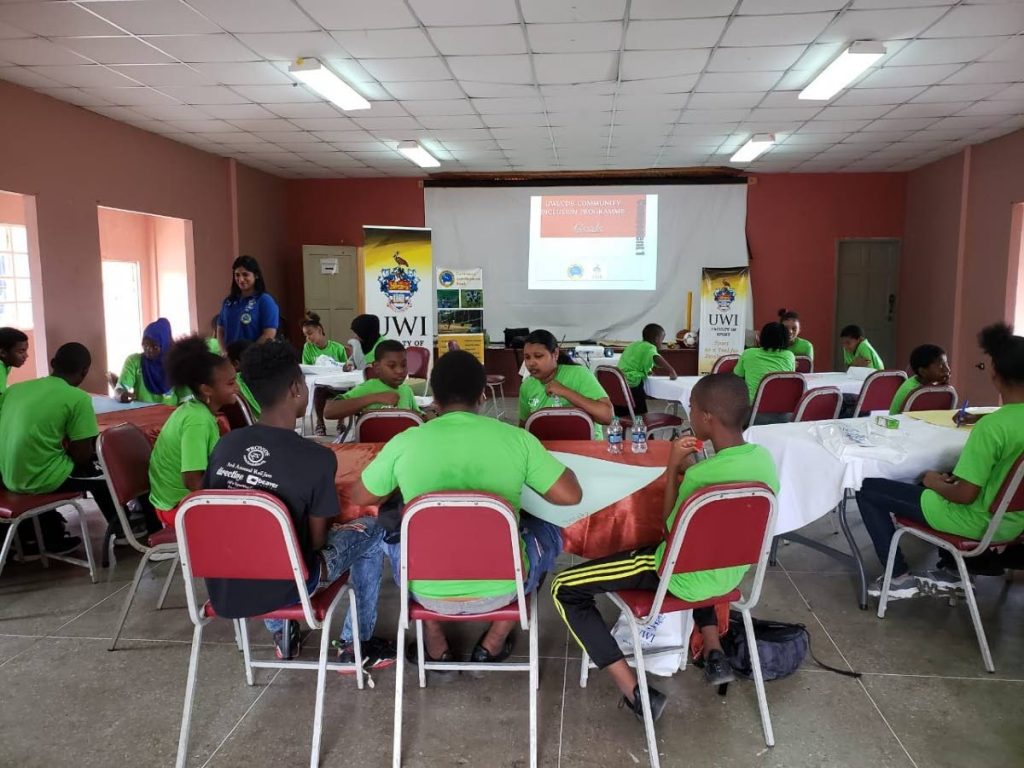 Youngsters take part at the launch of the University of the West Indies and Caribbean Development Bank Community Inclusion Programme yesterday, at Cane Farm Kandahar Community Centre, Crown Street, Tacarigua.