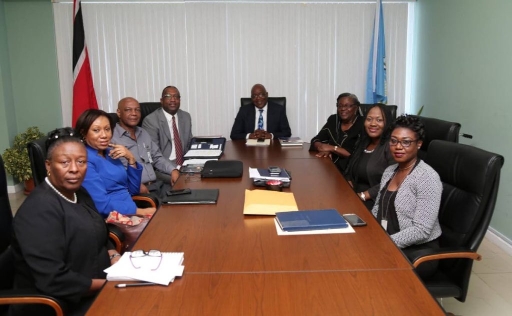 Chief Secretary Kelvin Charles, centre, held discussions recently on a University of Tobago. 