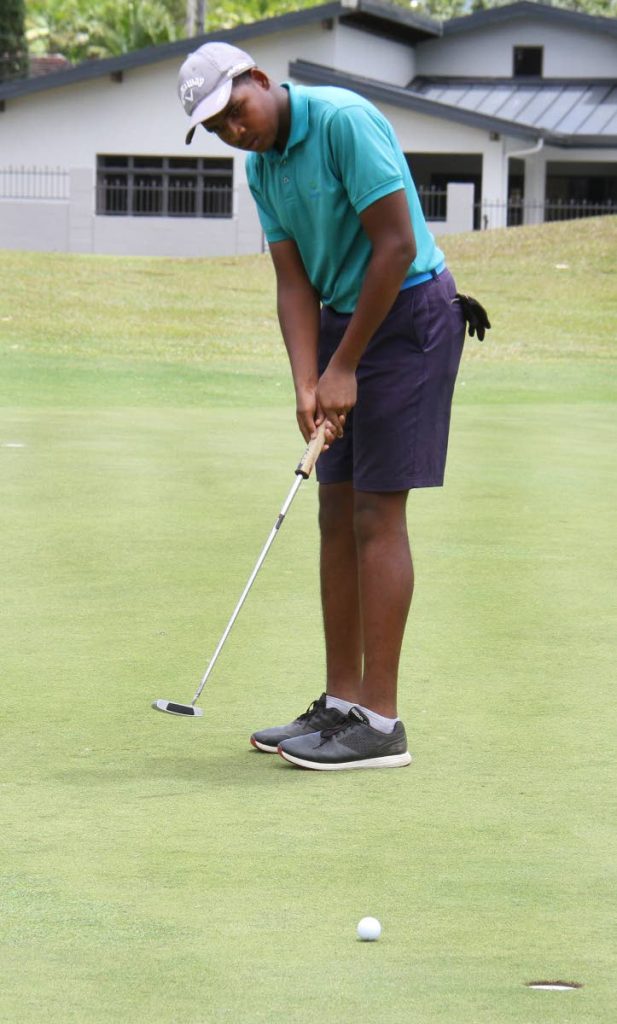 Jean-Marc Chevrotiere, plays a stroke in the Republic Bank Junior Open Boys 14-15 RBL Golf Tournament, at Moka, Maraval,yesterday.