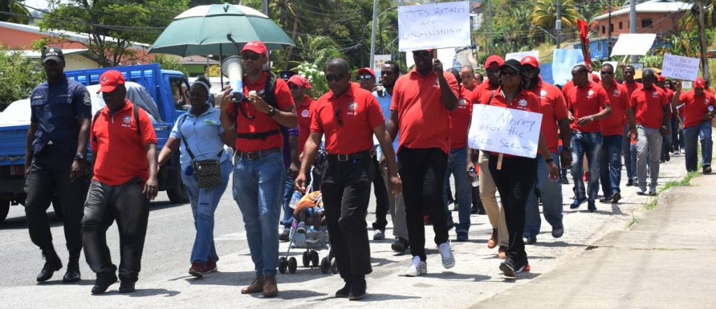 The Fire Services Association and members of the public march along Lady Young Rd during a rally from Morvant Fire Station to San Juan Fire Station to highlight issues within the service. 