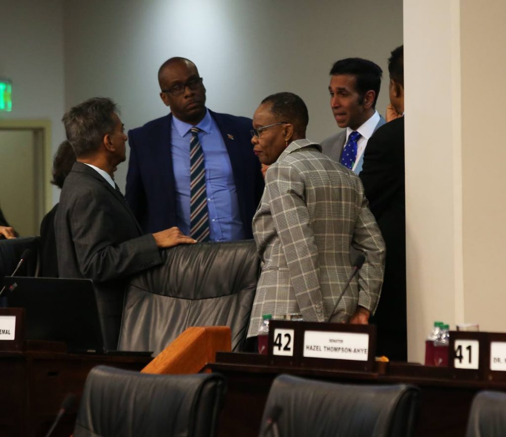 Attorney General Faris Al-Rawi, right, has a conversation with Independent Senators, from left, Dr Varma Deyalsingh, Paul Richards and Dr Maria Dillon-Remy during yesterday's sitting of the Senate in Parliament yesterday.