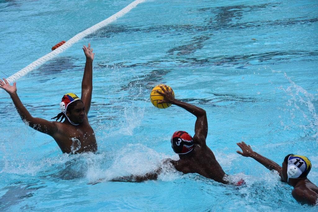 ON THE ATTACK: TT's Under-19 water polo men look to score against Bahamas yesterday. 