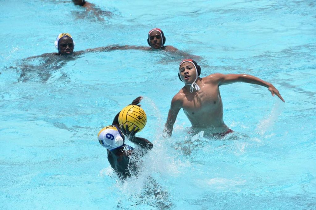 TT's Ross Gillette gets close on defence against his Barbados opponent in the Carifta Water Polo Championships in Wildey, Barbados. 