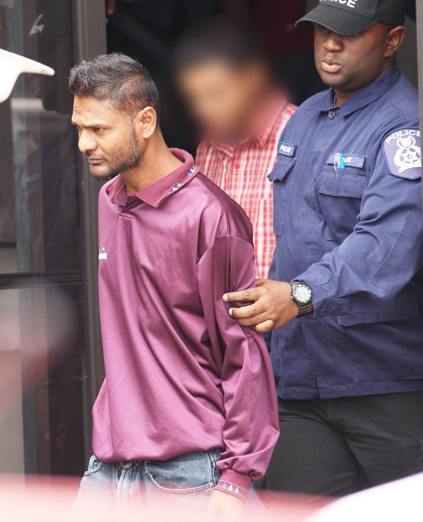 CHARGED: Keshan Bajnathsingh is taken to the Siparia Magistrates' Court yesterday charged with the murder of his common-law wife Leisha Ramnath.   PHOTO BY LINCOLN HOLDER


Holder                                      15-4-19