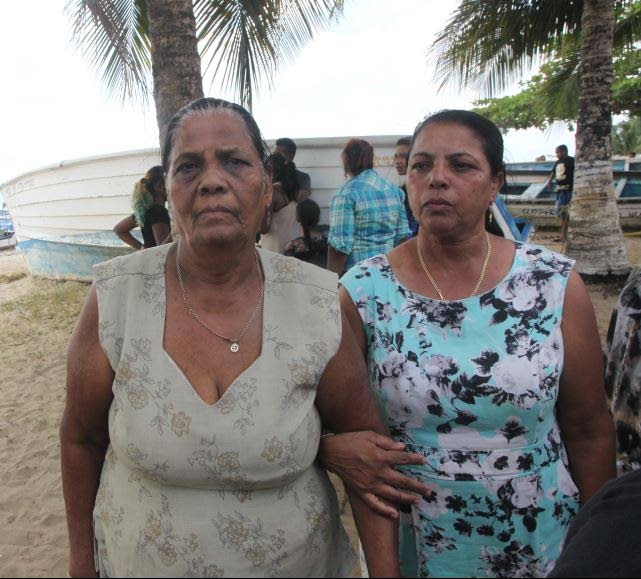 Etwaria Gyandass (Left), 74, stands with a relative at Carli Bay, Couva.  Photo by Lincoln Holder.