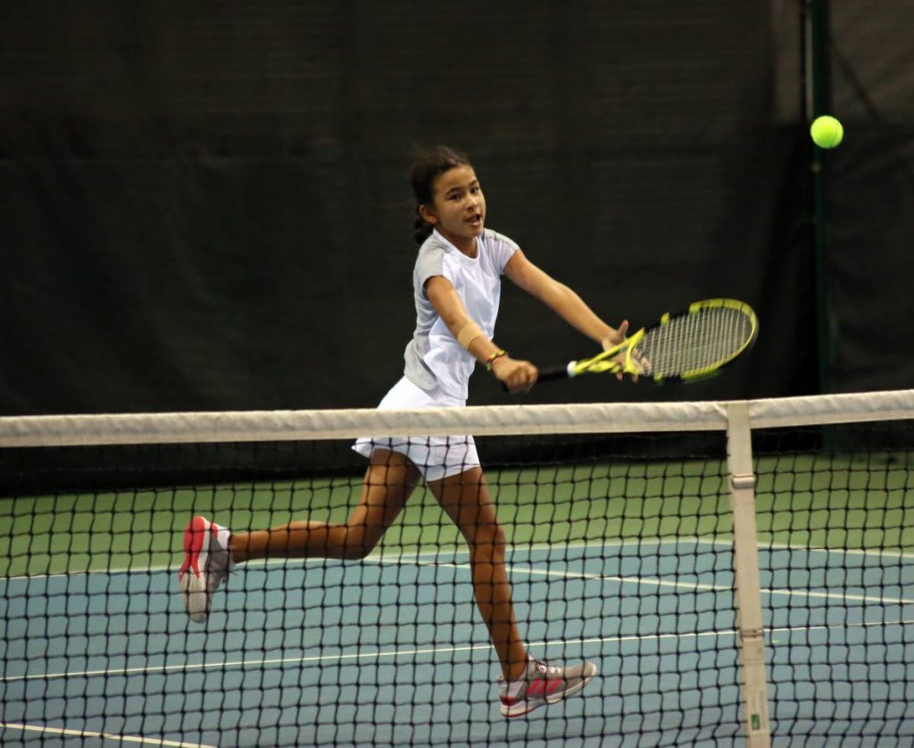 Jordane Dookie 
returns to Jaeda-Lee Daniel-Joseph, in the girls Under-12 final, at the Catch National Junior Tennis Championship, at the National Racquet Centre, Tacarigua, yesterday.