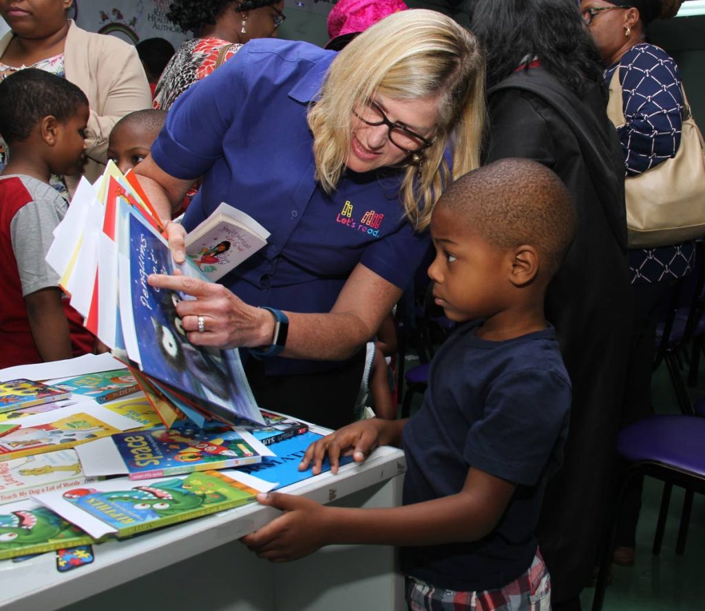  Alison de la Bastide of NGO Let’s Read interacts with young Silas de Verteuil at the launch last wek of the Book a Baby initiative at the Children’s Assessment Unit in Barataria. 
