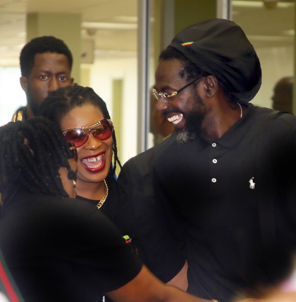 Buju banton interacts with fans as he arrives at the old Piarco airport terminal on Friday.   PHOTO BY SUREASH CHOLAI