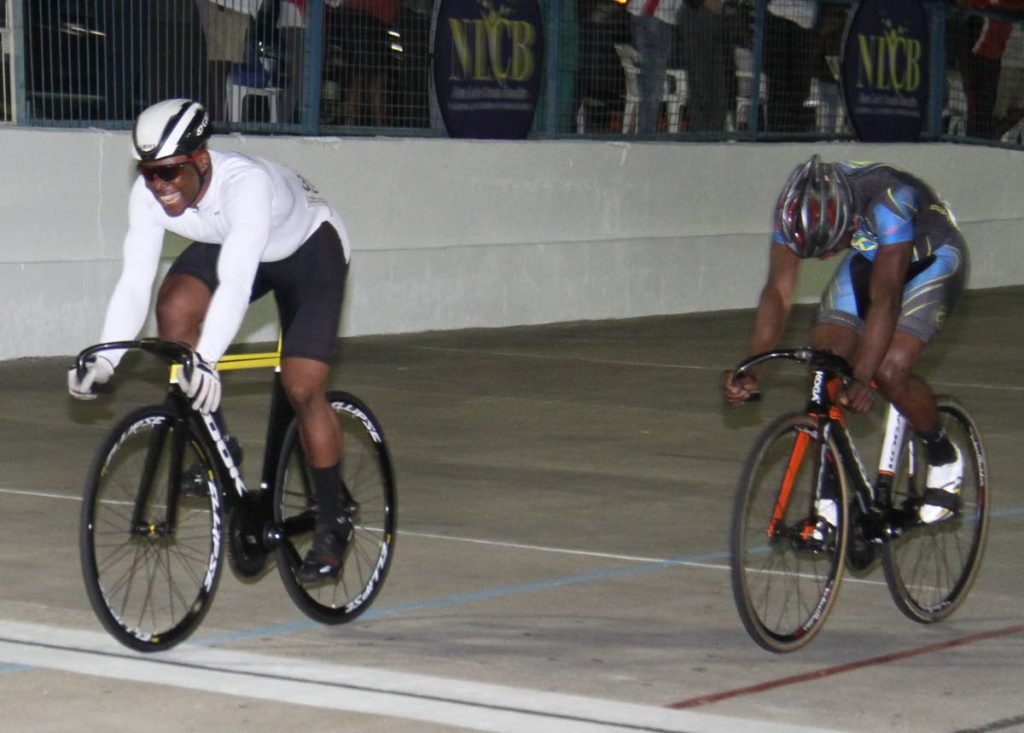 Nicholas Paul, left, wins the Keirin Finals International/Invitational 3 lap race, in the Madonna Wheelers Easter Grand Prix, on Friday evening, at the Arima Velodrome.