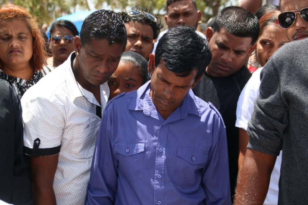 Survivor Kumar Lalla is seen looking on as the funeral of Ronald Narinesingh took place yesterday