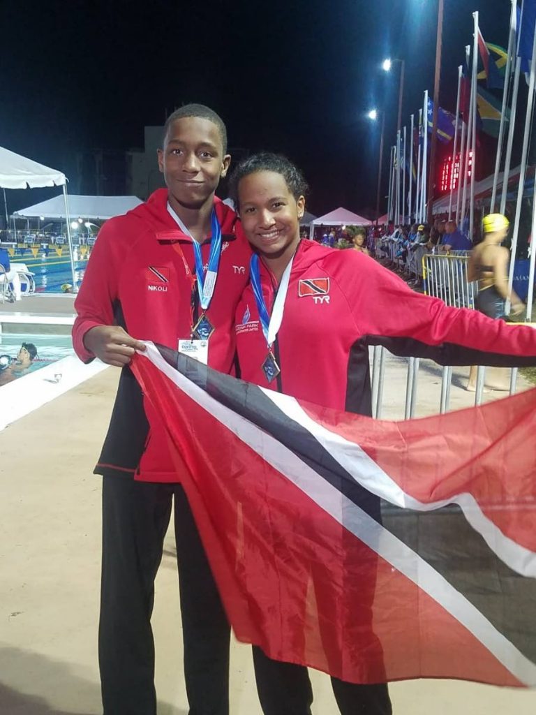 TT swimmers Nickolai Blackman, left, and Jada Chatoor with their Carifta gold medals in Barbados yesterday. 