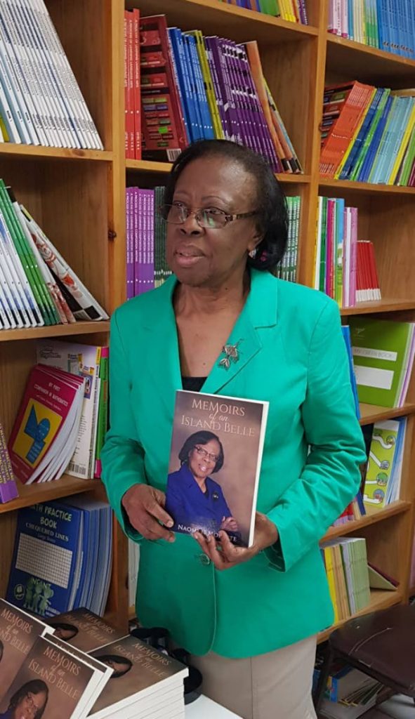 Naomi Modester shows a copy of her new book, Memoirs of an Island Belle, which details life growing up in a small Tobago village. 