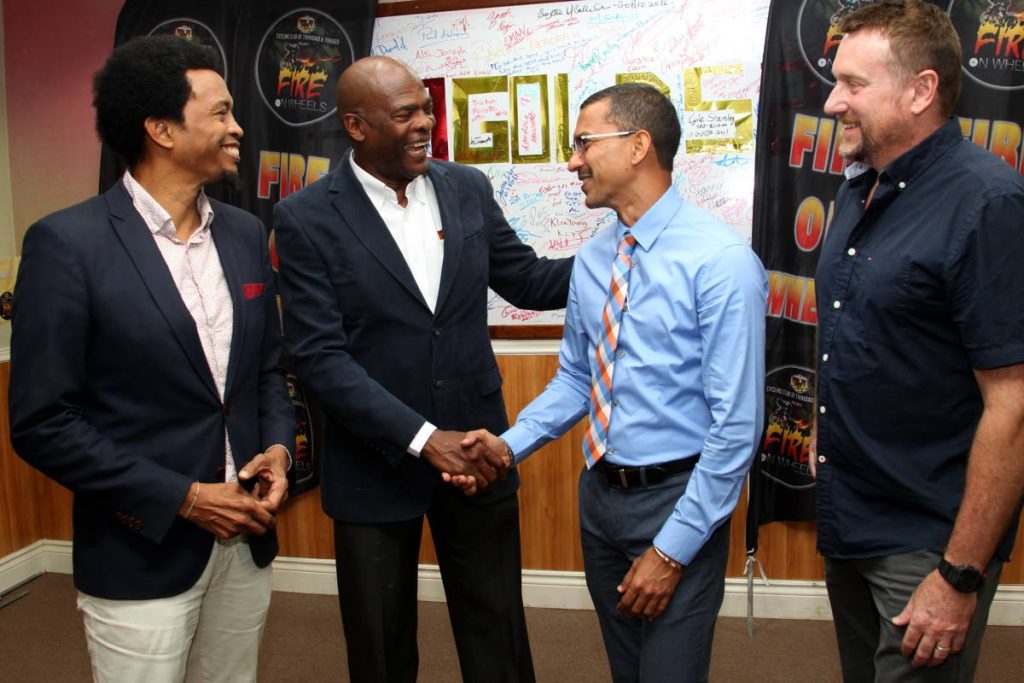 (L-R) Brian Lewis, president of TTOC, Desmond Roberts CEO of PSL, Marcus Girdharie, managing director of Marjen Financial and Erin Hartwell, National Technical Director for Cycling chat, at the Olympic House, Abercromby Street, PoS yesterday, during the launch of the PCL Cycling Club’s Fire on Wheels due to be held on June 1 and 2.