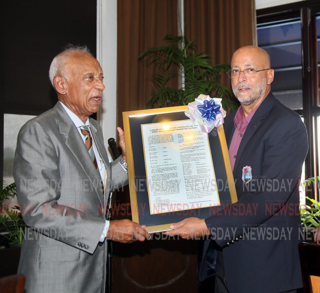 President of Queen's Park Cricket Club  Ken Gordon left presents  Ricky Skerritt new President of Cricket West Indies with a memorabilia during a luncheon with cricket stakeholders at Jaffa at the Oval .PHOTO SUREASH CHOLAI