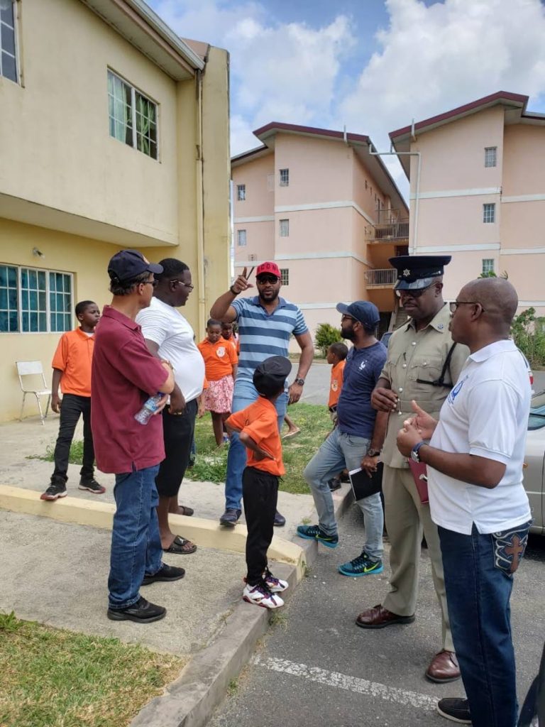 HDC divisional manager Estate Management Larry McDonald, centre, speaks with residents of Sixth Avenue, Oropune Gardens, Piarco, during a community walkabout hosted by the Arouca Police on Saturday. Looking on are, ASP Jackman, second from right, and Insp Keith Phillips, right, in charge of the Police Youth Club Secretariat.