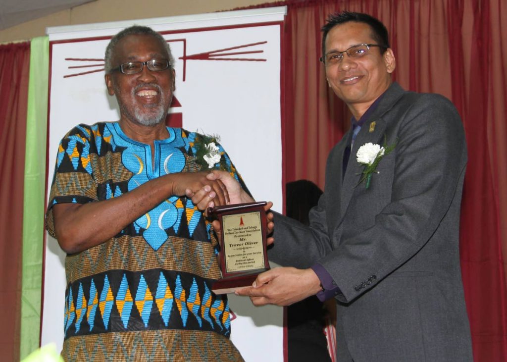 Retired principal and former president of TTUTA Trevor Olliver, left, receives a token of appreciation from current president Linsley A Doodhai at the Retirees 40th Anniversary function held at Centre Pointe Mall Auditorium, Chaguanas,  on Staurday evening. 