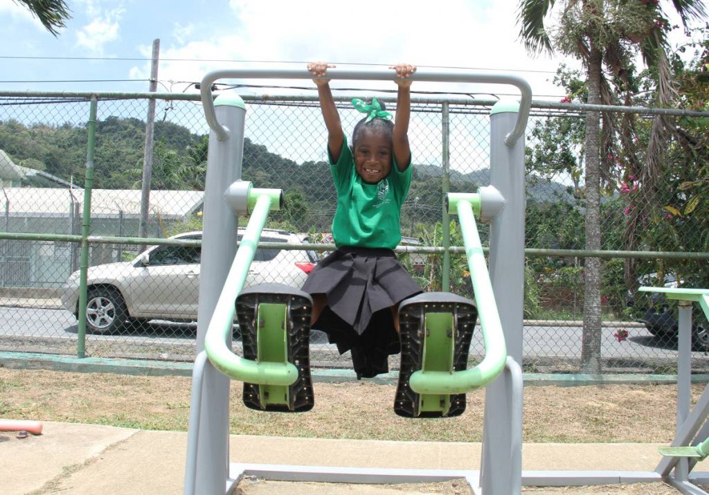 Zahria Stevenson enjoys herself on an exercising machine at the Patna Village Recreation Grounds during the US Embassy and the Diego Martin Corporation Sports Caravan yesterday. PHOTO BY AYANNA KINSALE 