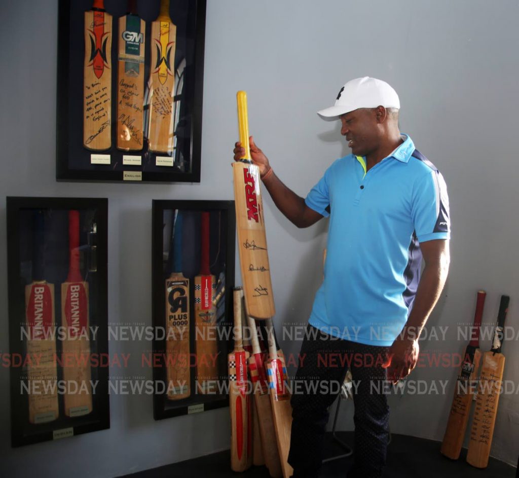 THE LEGEND: Windies icon Brian Lara shows the media some of his bats used to score his epic hundreds on a tour of his home today. PHOTO BY SUREASH CHOLAI 