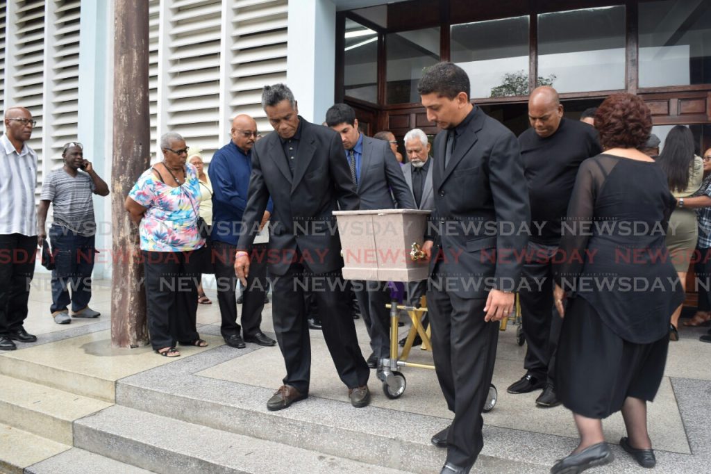 Mourners carry the coffin of David Cameron, Trini Revellers' band leader held at the Church of Assumption Long Circular Road, Maraval on Tuesday.

Photos: Vidya Thurab