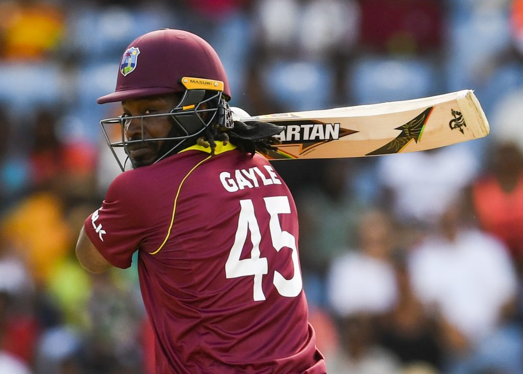 (FILES) In this file photo taken on February 27, 2019, Chris Gayle of West Indies hits 4 during the 4th ODI between West Indies and England at Grenada National Cricket Stadium, Saint George's, Grenada. - Gayle says he is reconsidering his decision to retire after this year's World Cup after the West Indies' opener's record-breaking feats in the ongoing one-day series against England. The 39-year-old smashed a 97-ball 162 in a losing cause in Wednesday's fourth game, and has now struck 305 ODI sixes and a record 506 in all internationals. (Photo by Randy Brooks / AFP)