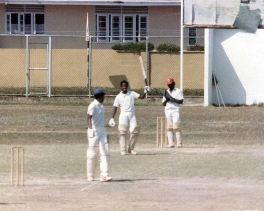 THE PRINCE: West Indies legend Brian Lara raises his bat to celebrate a century for Fatima College in 1987 at Fatima ground, Mucurapo. At the other end with Lara is Robert Wickham. PHOTO BY RONALD DANIEL