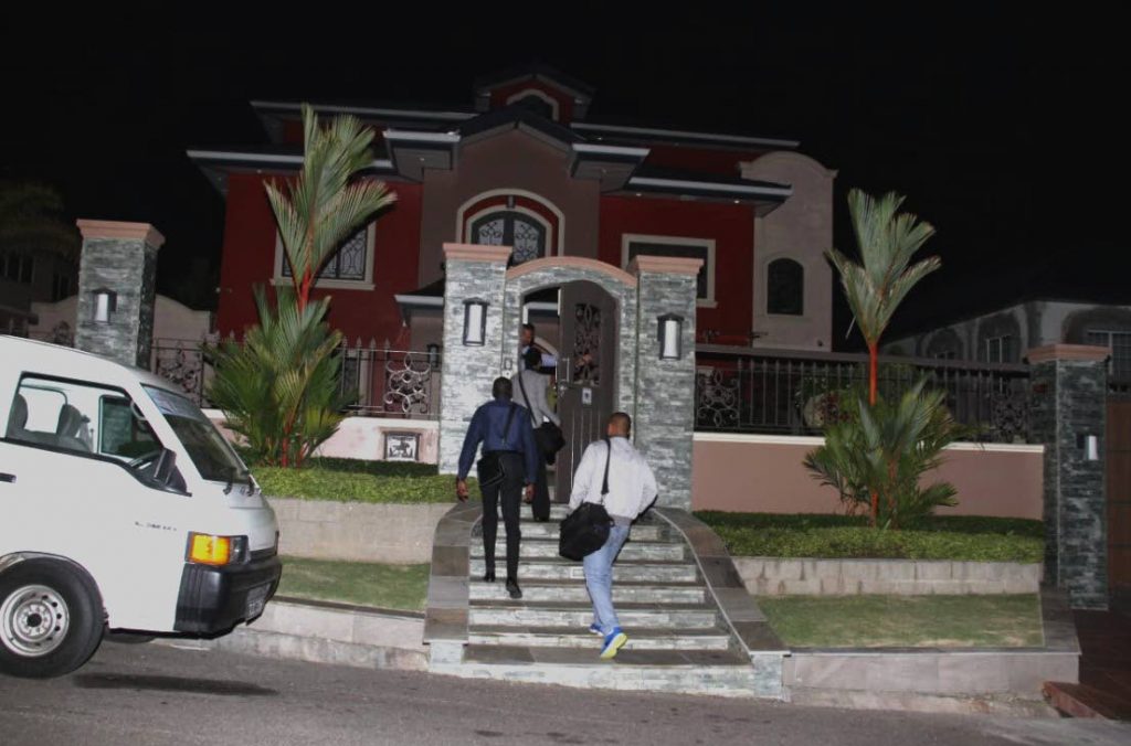 NIGHT SEARCH: Police arrive at a house in South Trinidad last night relative to ongoing investigations. The search took place hours after former Attorney General Anand Ramlogan and UNC Senator Gerald Ramdeen were arrested.  PHOTO BY VASHTI SINGH