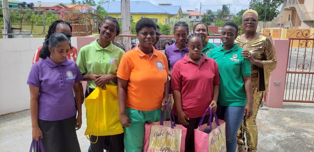Participants of the Tobago Technical Vocational Centre for Persons with Disabilities with their hampers alongside members of Yoshabell Foundation last week. 