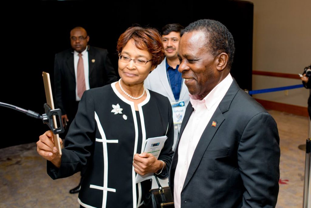CHECK IT OUT: Caribbean Telecommunications Union (CTU) secretary general Bernadette Lewis (left) demonstrates the use of facial recognition to Prime Minister Dr Keith Mitchell during a tour of Caribbean FutureScape at the CTU 30th anniversary week of ICT-related activities held last week at the Hyatt Regency, Port of Spain. 
