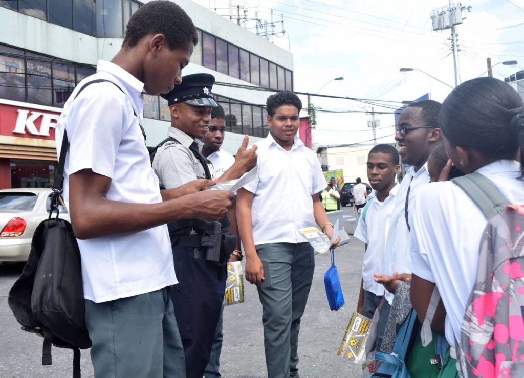 LEARN WELL:  PC Adrian Sealy of the San Fernando Traffic Branch speaks to students of St Kevin's College about road safety.   PHOTO BY VIDYA THURAB