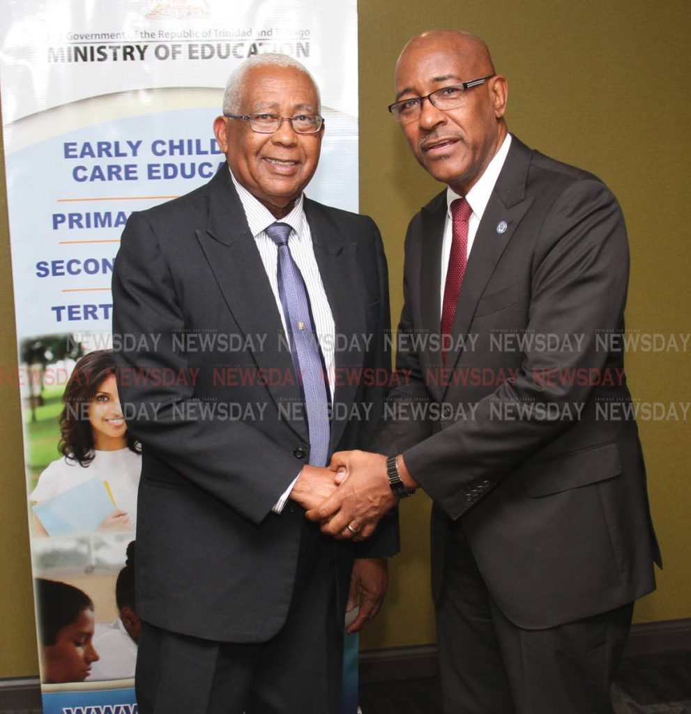 Minister of Education Anthony Garcia, left, and Minister of Public Utilities Robert Le Hunte, shake hands after a press conference at the Ministry of Education, Port of Spain, on Friday. PHOTO BY ANGELO M MARCELLE