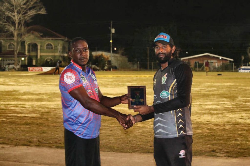 HKL Aranguez’ Rishard Harris ,left, receives the man of the match award from national player Imran Khan after his side beat South Boys All Stars by eight wickets, in the Central Super League match recently.