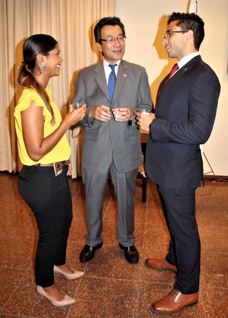 Japan's ambassador to TT Tatsuo Hirayama chats with Shannon Fernandez and Adrian Imbert.