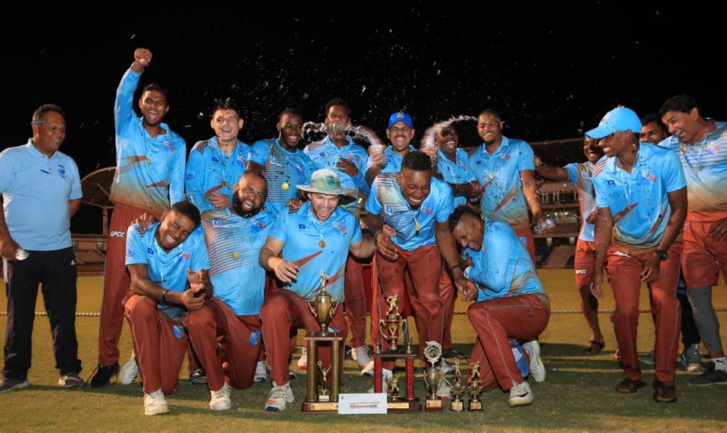 Queen’s Park players and staff celebrate their victory in the TTCB Premiership 50-overs final on Sunday evening. 