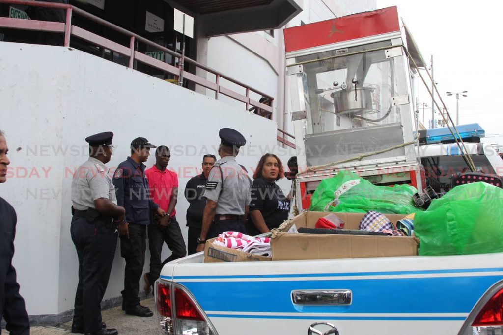 A popcorn machine belonging to vendor Kevin Thomas is brought to the San Fernando magistrates court to be presented as evidence on Tuesday. PHOTO BY LINCOLN HOLDER