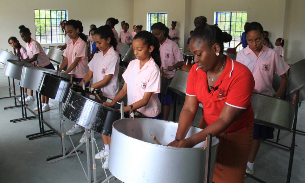 Anna Noel, artistic director of the Guaico Presbyterian Steel Orchestra, practises with her 
students last Wednesday. PHOTO BY AYANNA KINSALE. 
