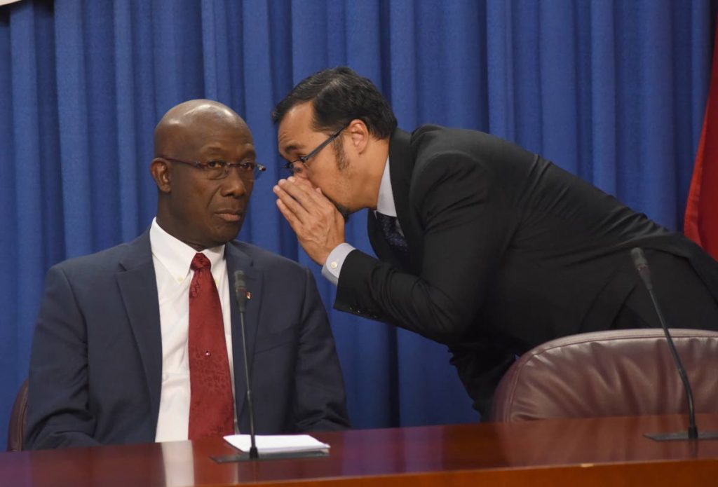  National Security Minister Stuart Young has a private conversation with the Prime Minister at yesterday’s post-Cabinet news conference at the Diplomatic Centre in St Ann’s. 