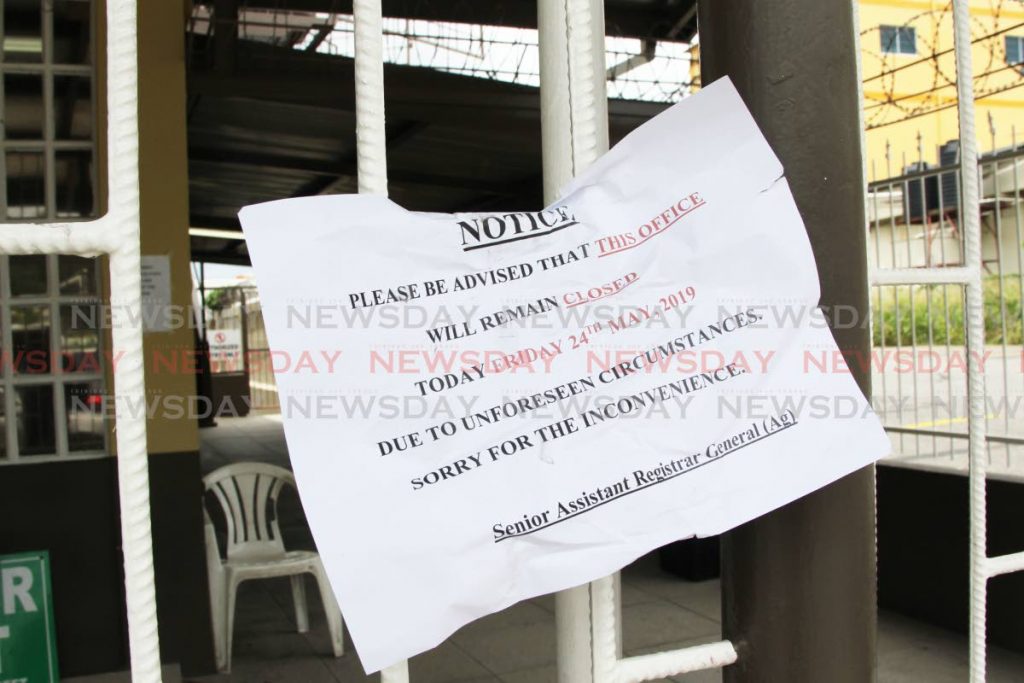 A notice posted outside the closed office of the Ministry of Legal Affairs on Leotaud St, San Fernando, yesterday. PHOTO BY LINCOLN HOLDER