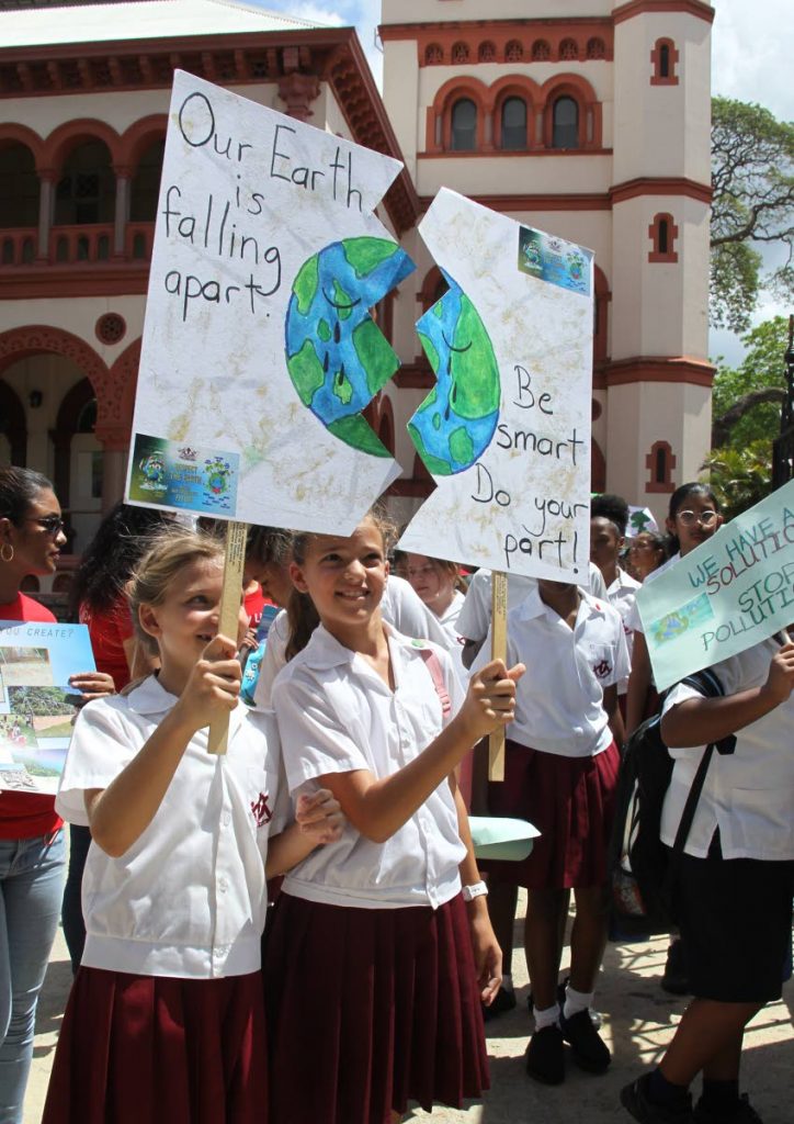 File Photo: Gabriella Chaves and Zoe Camacho, both of St Bernadette’s Prep School in St Ann's, hold up their unique poster illustrating the need to protect “Mother Earth” at the Laudato Si’ Generation Climate Change march, at Jackson Square, opposited the Archbishop’s residence in St Clair, May 2019.