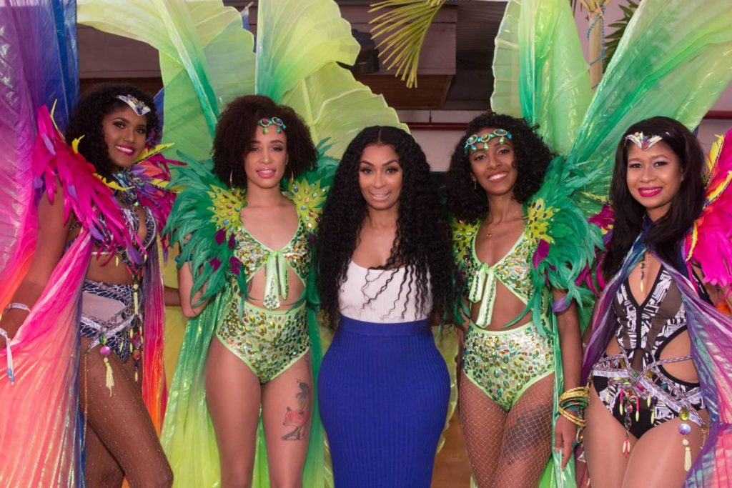Love and Hip Hop Atlanta star Karlie Redd pose with masqueraders from Lost Tribe’s Talent Bank.
