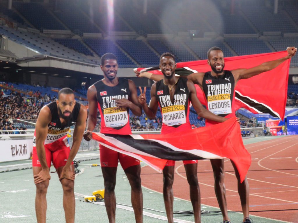 TT's  champion quartet (from left) Machel Cedenio, Asa Guevara, Jereem Richards and Deon Lendore with the national flag after winning the 4x400m final at the IAAF World Relays in Yokohama, Japan today. PHOTO COURTESY IAAF WORLD RELAYS