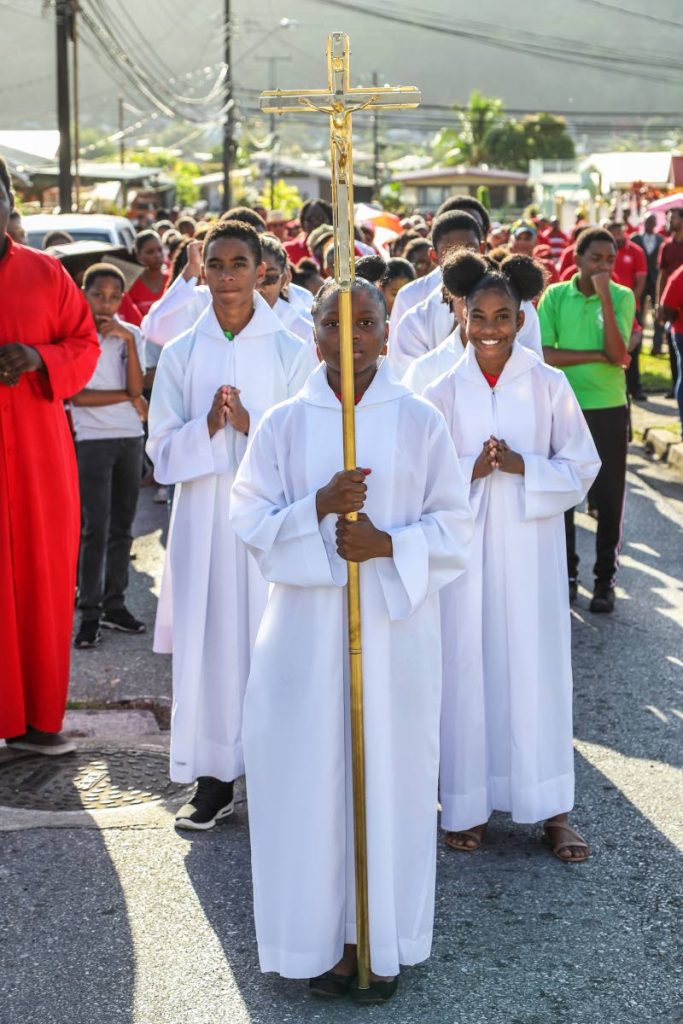 Roman Catholic and Anglican
parishioners during the stations of the cross in Diego Martin in April. Christian worship is opening up to include the Spanish-speaking community.
PHOTO BY JEFF K MAYERS 