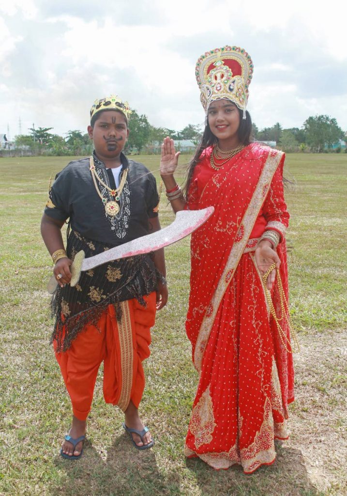 Trishna Sookdeo and her brother Deviq in character as Mother Lakshmi and Ravana at Francis Sepaul Recreational Grounds, Debe last Thursday. They performed as the Hindu goddess and god during Indian Arrival Day celebrations at Parvati Girls’ Hindu College. PHOTO BY CHEQUANA WHEELER