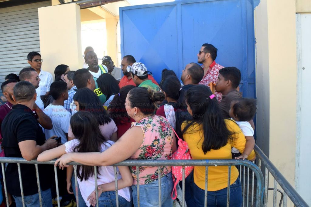 Venezuelans gather outside the gates of Queen's Park Oval on Havelock Street, Port of Spain in an early morning rush to register which slowed to a trickle by noon on Saturday. PHOTO BY VIDYA THURAB