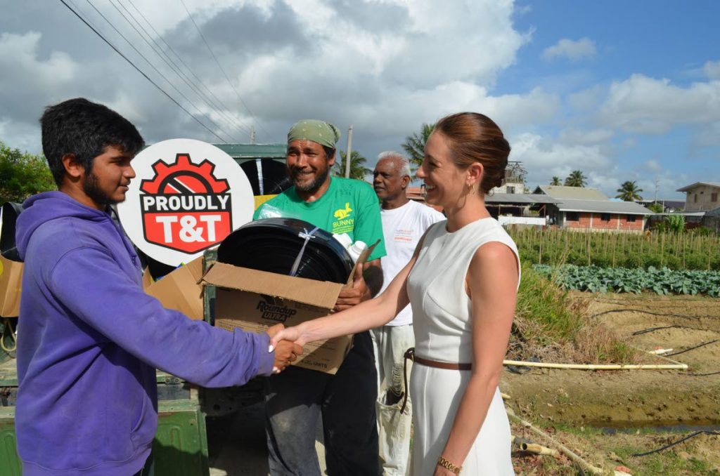 TTMA president Franka Costelloe gives a hamper to a young farmer in Aranguez yesterday. PHOTO COURTESY TTMA