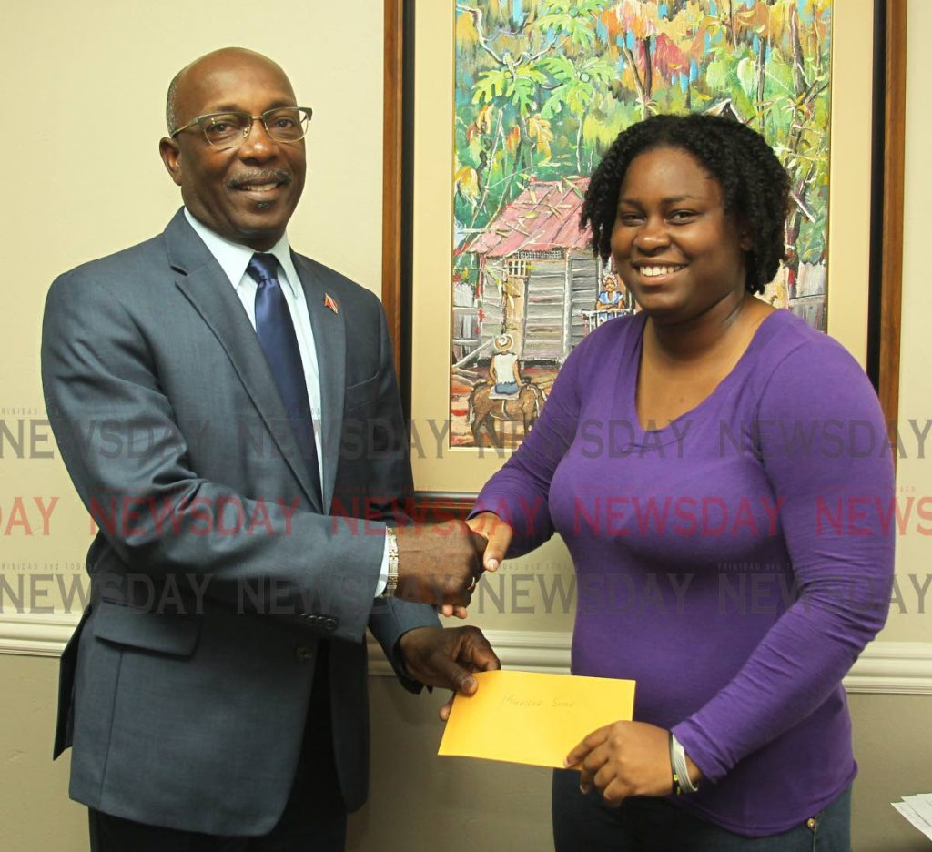 Makeisha Simon, receives a cheque donation from Newman George, Chairman of HDC, in his personnal capacity to help assist her in fund her dream of becoming a doctor,
Office of the Chairman, Housing Development Corporation, Port of Spain. Tuesday, June 4, 2019. PHOTO BY ROGER JACOB.  