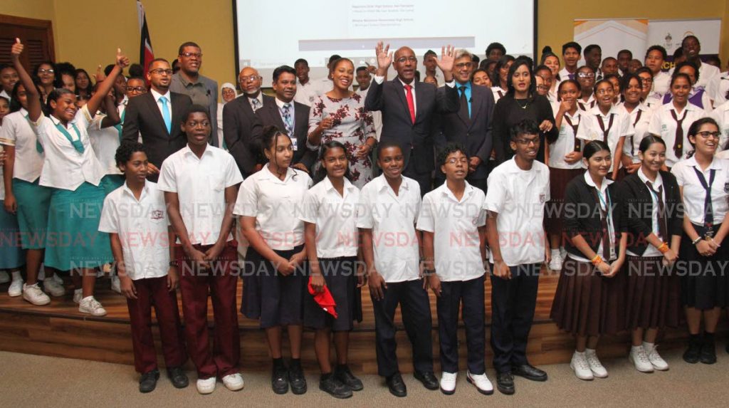 Minister of Public Utilities Robert Le Hunte, hands raised, to his right and left respectfully is NGC CNG President, Curtis Mohamed and SWMCOL Acting Chief CEO, Aisha Roach, take photos with students at the World Environment Day, 'Air Pollution', at Yara Auditorium, UWI-Arthur Lok Jack Global School of Business.

PHOTO:ANGELO M. MARCELLE