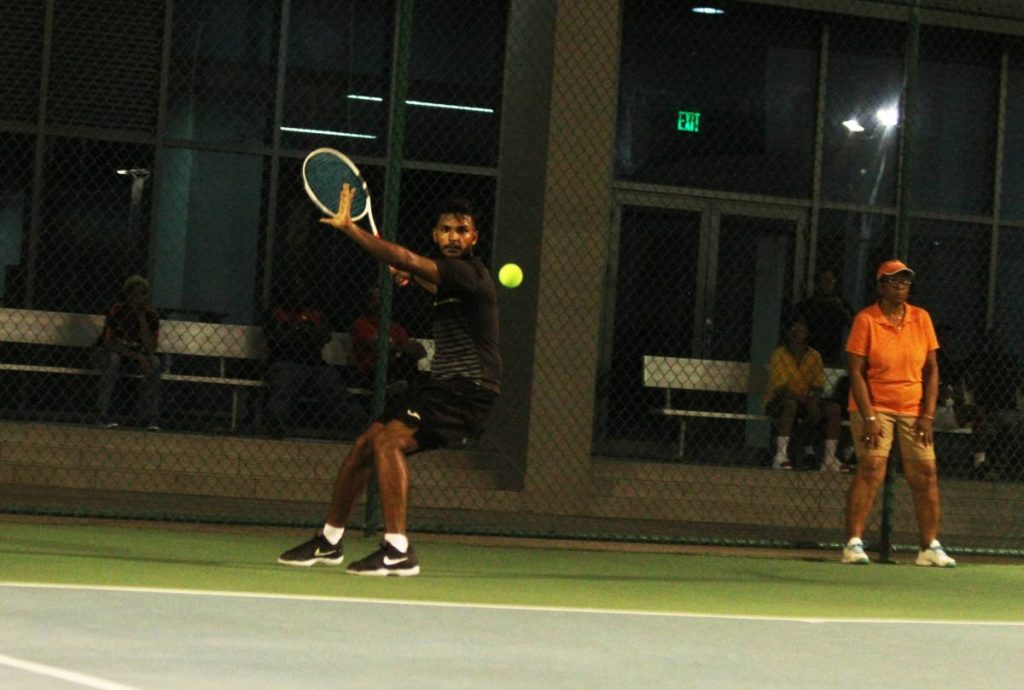 Nabeel Mohammed looks to play a shot against Richard Chung during their men’s singles semi final match, at the National Tennis Championships, held at the National Racquet Centre, Tacarigua, yesterday.
